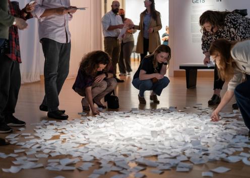 Guests pick up notes from the exhibit